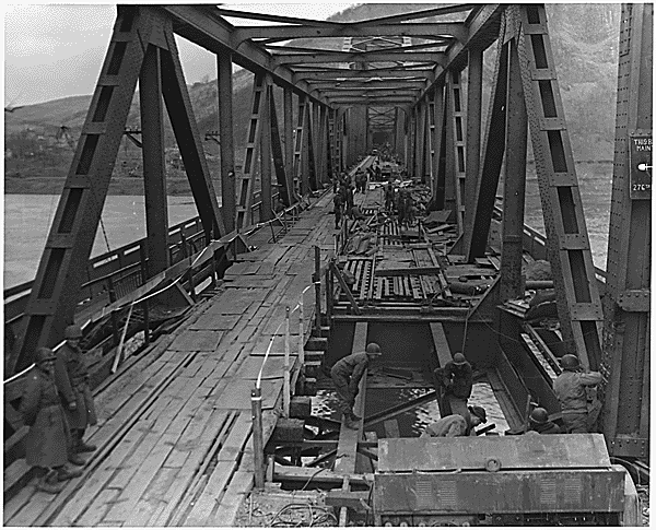 soldiers repairing floor of a bridge